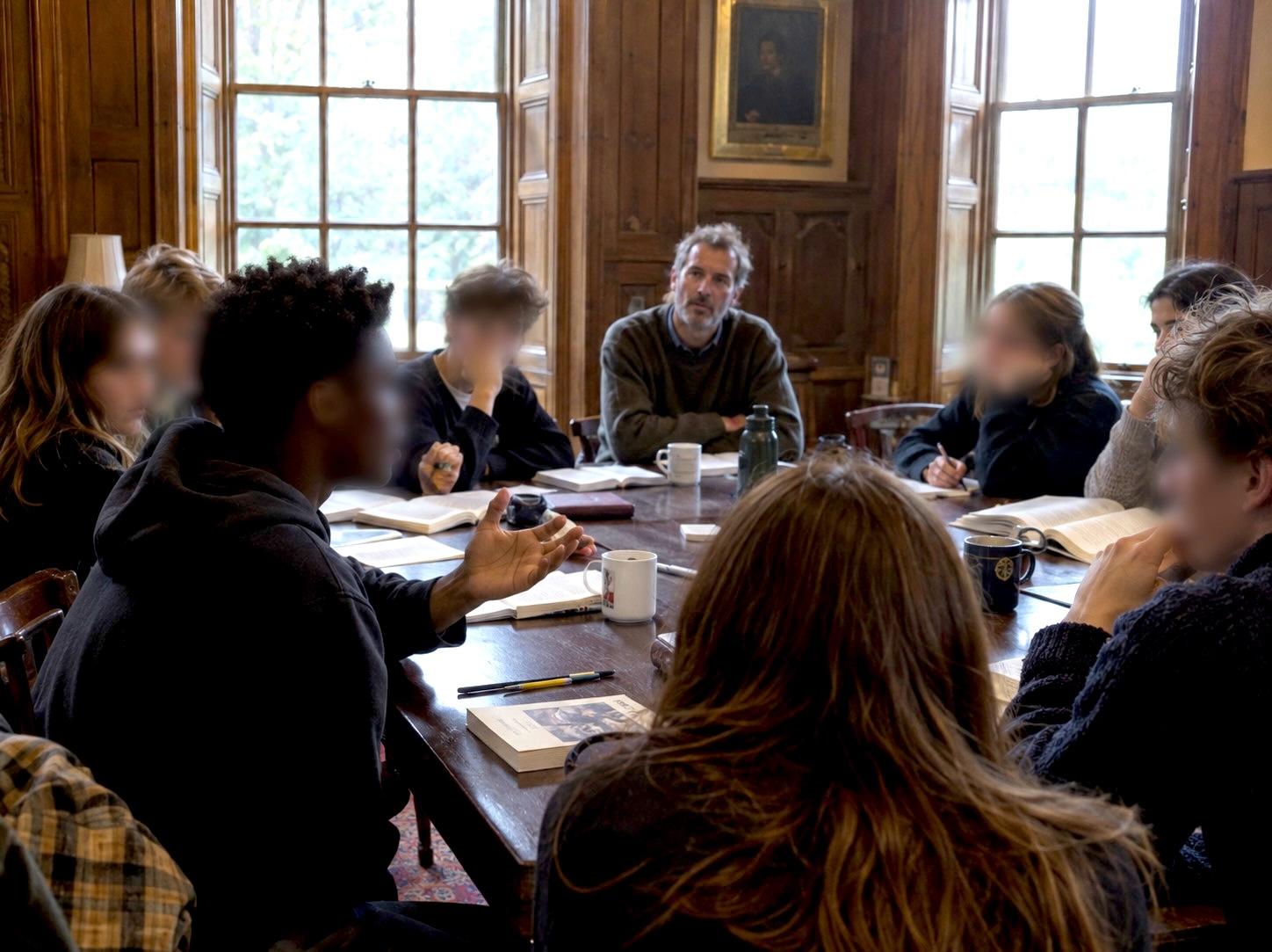 Students in a seminar around the long oak table